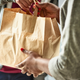 person handing shopping bag to other person